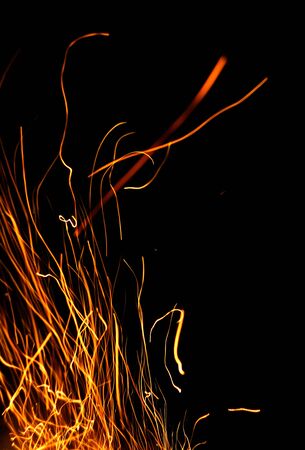 Sparks and flames erupt from a fireの写真素材