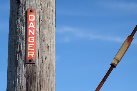 Red and white danger sign on a pylonの写真素材