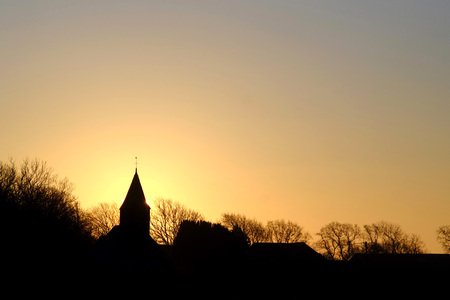 Small country parish church steeple at sunriseの写真素材