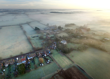 Aerial images of a small English village on a frosty and misty morningの写真素材