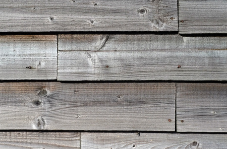 Close up of weathered wooden cladding on a barnの写真素材