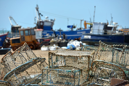 Old fishing nets and lobster pots on Hastings Beach, East Sussex.の写真素材