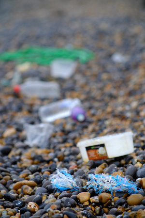 Plastic rubbish washed up on a shingle beachの写真素材