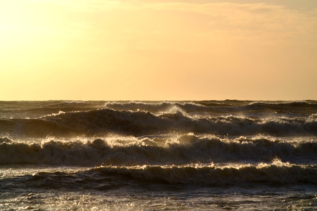 Rough seas and waves at sun setの写真素材