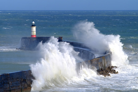 Large waves crashing over Newhaven harbour, East Sussex, UKの写真素材