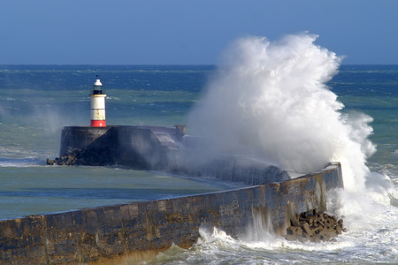 Large waves crashing over Newhaven harbour, East Sussex, UKの写真素材