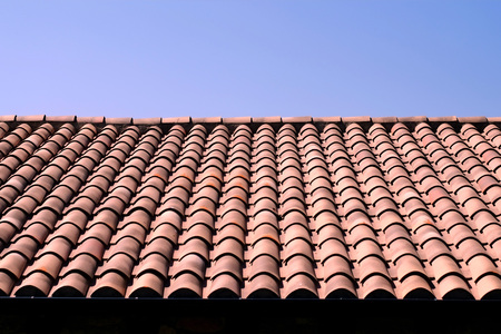 Traditional Spanish teracotta tiled roof with a blue sky