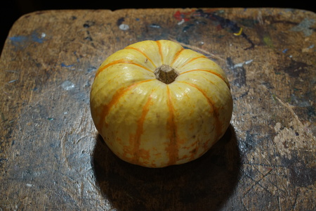 Small pumpkin or squash on a wooden board.の写真素材