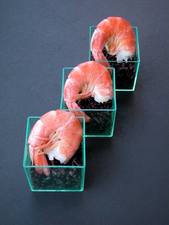 Prawns with black rice on dark gray backgroundの写真素材