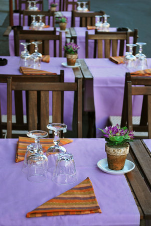 Violet and orange table setting in outdoor restaurantの写真素材