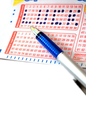 Closeup detail of a lottery ticket and a pen writing lucky wordの写真素材