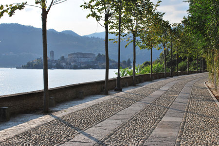 Romantic promenade by Orta lake, view on St. Giulio island, Italy