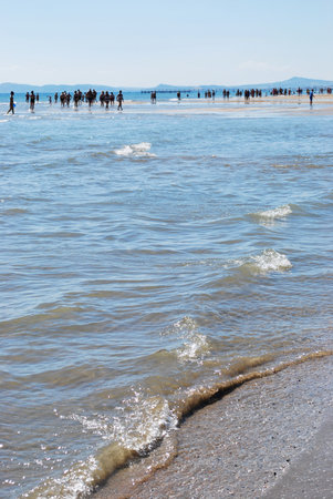Coastline and people walking on the beach, Rimini, Italyの写真素材