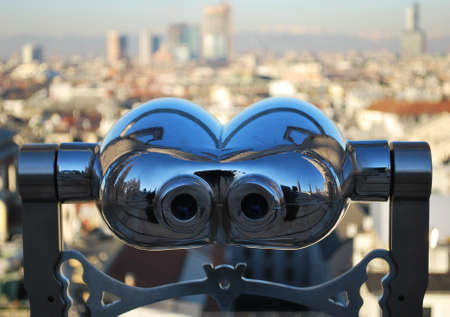Binoculars telescope looking Milan panorama from the roof of the Duomo cathedral, Lombardy, Italyの写真素材