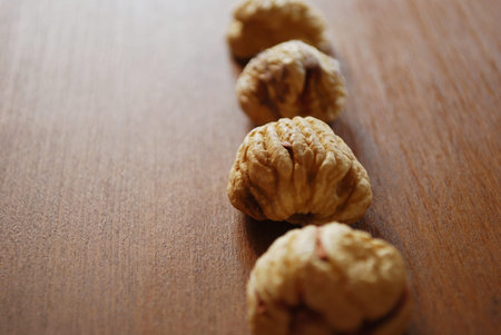 Dried chestnuts on natural wooden table background, free copy spaceの写真素材