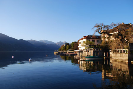 Beautiful ancient houses at sunset on Orta lake, Orta St. Giulio village, Piedmont, Italy