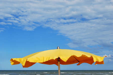 Yellow umbrella on the beach, Rimini, Italyの写真素材