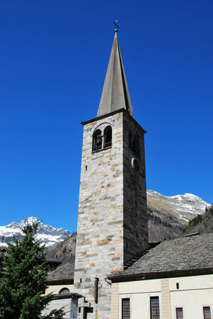Small church and tower bell in Alagna village on Alps mountains, Piedmont, Italyの写真素材