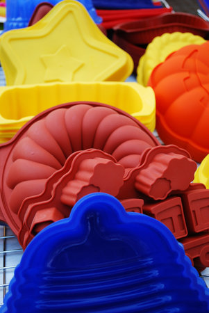 Colorful and differently shaped silicone baking pans as a background
