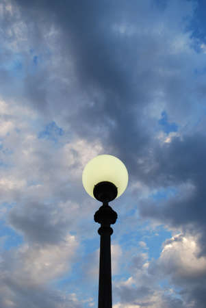 Street lamp at dusk on blue cloudy sky backgroundの写真素材