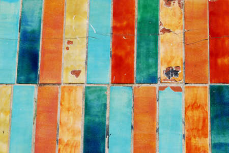 Vintage colorful damaged tiles background textureの写真素材