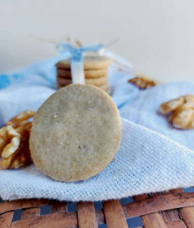 cookies with walnuts on a blue napkin on a white backgroundの写真素材