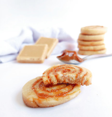 Butter cookies with caramel on a white background, selective focus.の写真素材