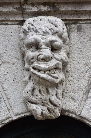 Old marble sculpture of a monster outside Santa Formosa Church belfry in Venice (17th century)の写真素材