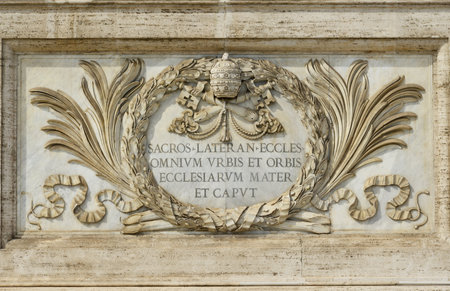 Marble panel in Saint John Basilica facade with papal coat of arms and latin inscription:" Mother and Head of all churches in Rome and in the World"のeditorial素材