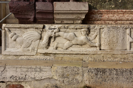 Medieval marble panel with a scene of a man eaten by a dragon, from Saint Mark Basilica southern facade in Veniceのeditorial素材