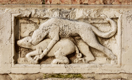 Medieval marble panel with a scene of prey between wild boar and wolf or feline, from Saint Mark Basilica southern facade in Veniceのeditorial素材