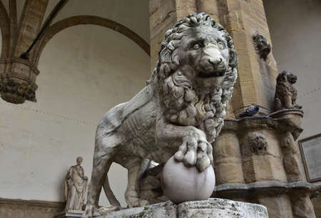 Doctors Lion holds the globe in Piazza della Signoria. Marble lion statues at the entrance (right side) of the Loggia dei Lanzi in Florence, an ancient roman sculputure from 2nd centuryの写真素材