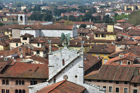 Beautiful romanesque San Michele in Foro thin marble facade seen from behind, right in the historic center of Luccaの写真素材