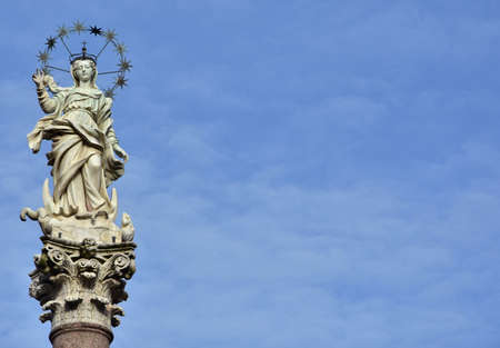 Mary of the Stars. Beautiful statue of Virgin Mary crush dragon and crescent in the historic center of Lucca, made by the artist Giovanni Lazzoni in 1687の写真素材