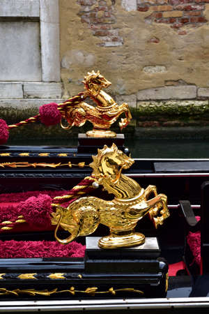 Golden Sea Horse, a traditional decoration on venetian gondolaの写真素材