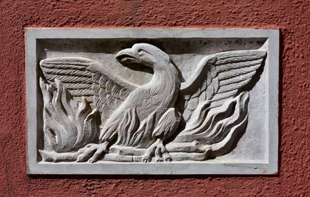 Old Patera (Venice public art) with phoenix theatre symbol on a wall near the famous opera houseの写真素材