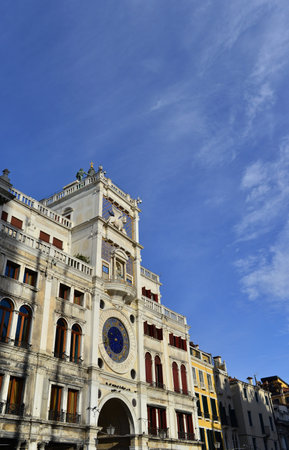 Saint Mark Square ancient Clock Tower in Venice, with blue sky and copy spaceの写真素材