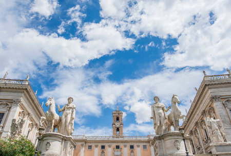 Capitol Hill in Rome with ancient roman statues, renaissance palaces and beautiful cloudsの写真素材