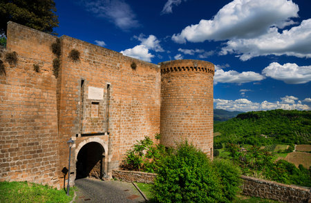 Orvieto ancient medieval city walls with gate and countryside panoramaのeditorial素材