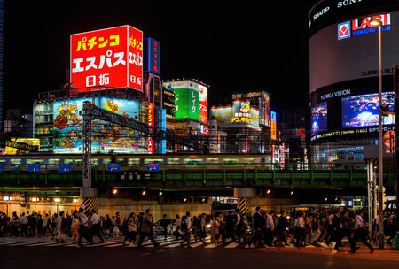 Tokyo, Japan, October 11, 2017: Night life in Tokyo. People cross a very busy crossroad below Shinjuku district lightsのeditorial素材