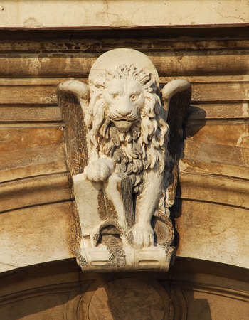 Saint Mark Winged Lion old relief on a venetian wall, symbol of the ancient Republic of Veniceの写真素材