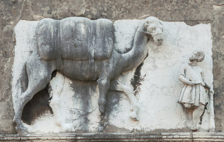 Moorish merchant with camel or dromedary old relief on a wall in the historic of Venice, along Rio della Sensa canal (15th-16th century, author unknown) の写真素材