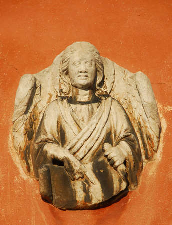 Angel holding a sacred scroll old relief on a Venice wallの写真素材