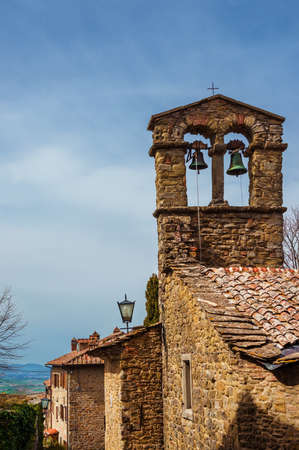 Cortona medieval historic center with old church belfry, in Tuscanyの写真素材