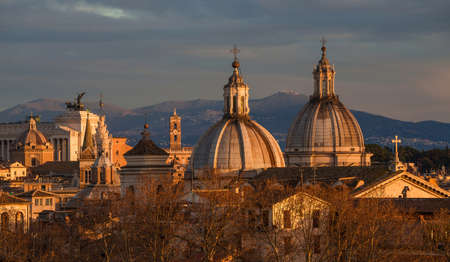 View of Rome historic center at sunset with baroque domes and Capitoline Hillの写真素材