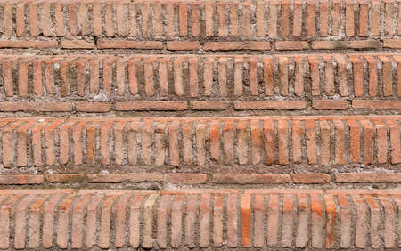 Old red brick steps with mortar as backgroundの写真素材