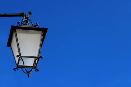 Old fashioned street lamp against blue sky (with copy space)の写真素材