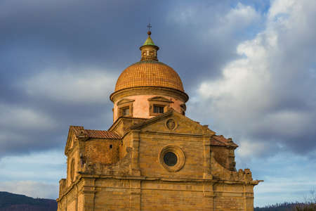 Santa Maria Nuova (Church of St Mary the New) with evening clouds in Cortona, Tuscany. Designed by the famous italian renaissance architect Giorgio Vasari and completed in the 17th century.の写真素材