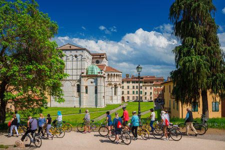 Lucca, Italy, May 5, 2018: Cycloturism in Lucca. Tourists visit the city beautiful medieval historic center in Tuscanyのeditorial素材