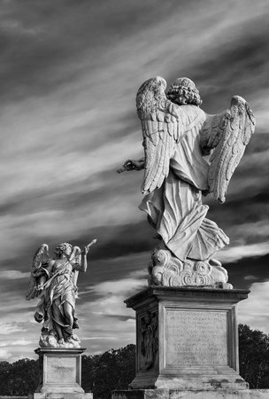 Angels statue with beautiful sky. Two 17th century baroque masterpiece at the top of Ponte Sant'Angelo monumental bridge in the center of Rome (Black and White)のeditorial素材